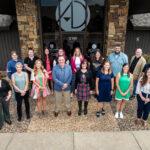 All team photo in front of building