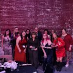 ADsmith team dressed up and posed for a picture holding their ADDY awards